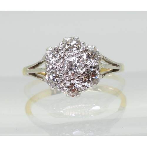 731 - An 18ct gold and platinum diamond flower ring with fleur de lis shoulders, set with estimated approx... 