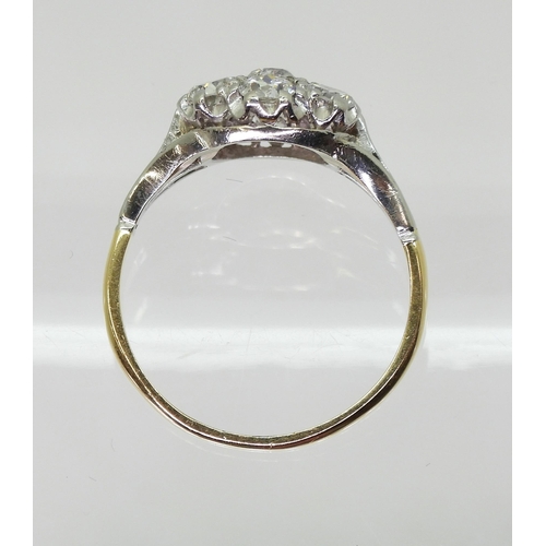 731 - An 18ct gold and platinum diamond flower ring with fleur de lis shoulders, set with estimated approx... 