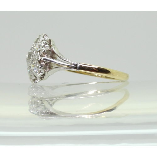 731 - An 18ct gold and platinum diamond flower ring with fleur de lis shoulders, set with estimated approx... 