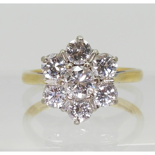 743 - An 18ct gold diamond flower ring set with estimated approx 1.30cts of brilliant cut diamonds, finger... 