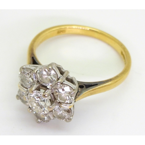 743 - An 18ct gold diamond flower ring set with estimated approx 1.30cts of brilliant cut diamonds, finger... 