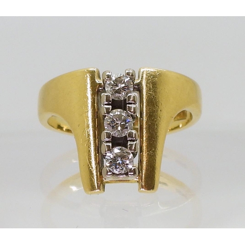 748 - An 18ct gold three stone retro design ring, with Sheffield hallmarks for 1978, finger size K1/2, wei... 