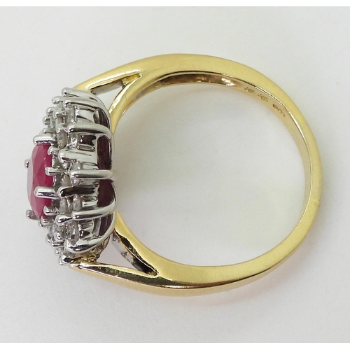 752 - An 18ct gold ruby and diamond cluster ring, set with a  8.7mm x 6.8mm, oval cut ruby, and set w... 