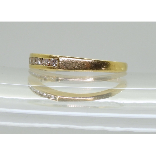 753B - An 18ct gold half eternity ring set with estimated approx 0.25cts of brilliant cut diamonds, finger ... 