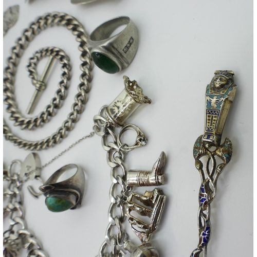 758 - A silver charm bracelet with a heart shaped clasp, with fourteen attached charms to include a George... 