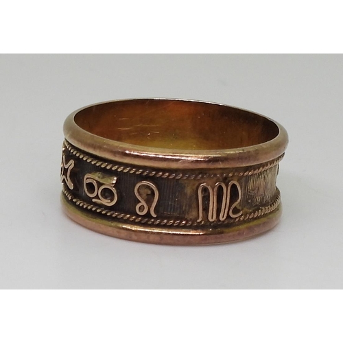 805 - An 18k gold ring with zodiac symbols, size V, weight 4.7gms