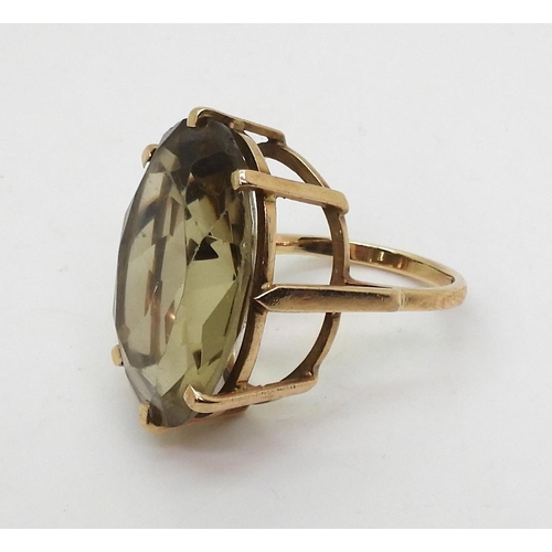 812 - A large smoky quartz ring in a yellow metal mount, stamped with the makers mark SRP, finger size P, ... 