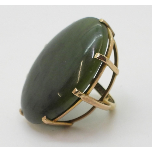 814 - A 9ct gold mounted very large green hardstone statement ring, approx size of the stone 4cm x 3cm, fi... 