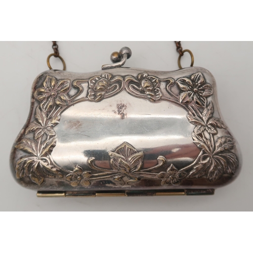 303 - A white metal ladies evening purse, stamped Ger. silver, decorated with stylised floral decoration, ... 