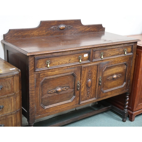 32 - A 20th century oak sideboard with two drawers over pair of cabinet doors on barley twist supports jo... 