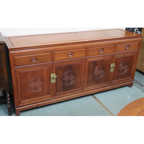 36 - A 20th century Chinese hardwood sideboard with shaped rectangular top over four short drawers over t... 