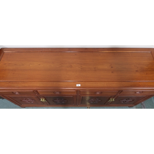 36 - A 20th century Chinese hardwood sideboard with shaped rectangular top over four short drawers over t... 