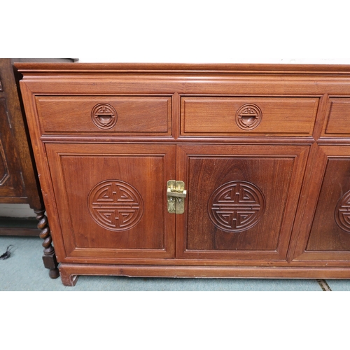 36 - A 20th century Chinese hardwood sideboard with shaped rectangular top over four short drawers over t... 