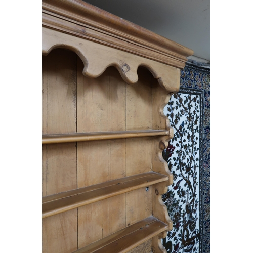 38 - A 20th century pine Welsh style kitchen dresser with open plate rack on base with three drawers over... 