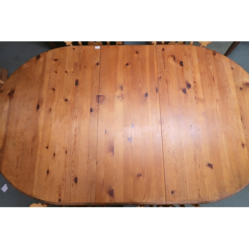 39 - A 20th century pine extending dining table and six chairs, table oval extending top with single leaf... 