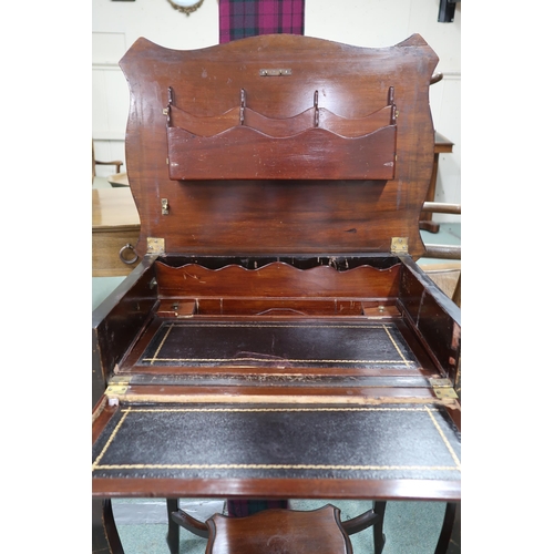 46 - A late Victorian mahogany desk with shaped hinged top concealing fitted writing compartment over sin... 