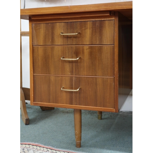 47 - A mid 20th century teak desk with shaped rectangular top over to banks of drawers on tapering suppor... 