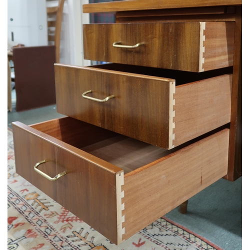 47 - A mid 20th century teak desk with shaped rectangular top over to banks of drawers on tapering suppor... 