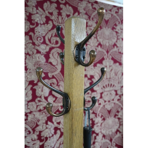 49 - A mid 20th century blonde oak coat/umbrella stand with copper coat hooks, 180cm high