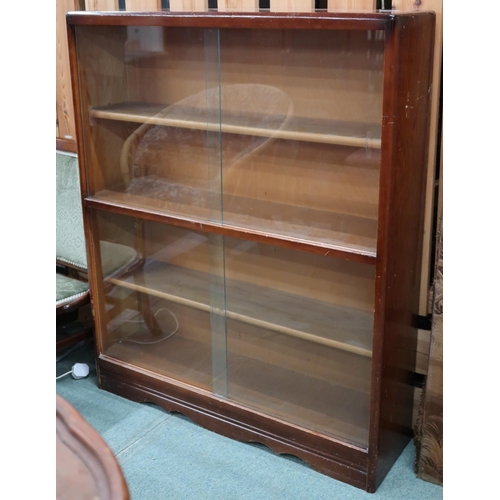 58 - A mid 20th century teak bookcase with glass sliding doors, 112cm high x 91cm wide x 26cm deep