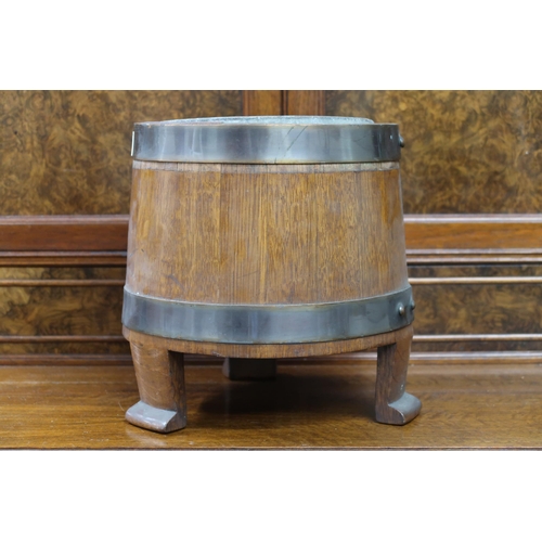 7 - A small early 20th century oak and brass coopered planter with metallic liner on three shaped feet, ... 