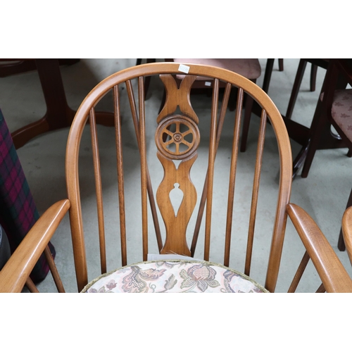 84 - A pair of mid 20th century Ercol elm and beech rail backed armchairs, 90cm high x 70cm wide x 90cm d... 