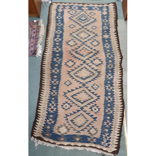 88 - A beige ground Persian tribal runner blue geometric patterned ground and borders, 282cm long x 140cm... 