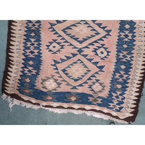 88 - A beige ground Persian tribal runner blue geometric patterned ground and borders, 282cm long x 140cm... 