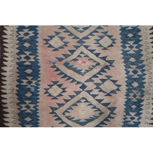 88 - A beige ground Persian tribal runner blue geometric patterned ground and borders, 282cm long x 140cm... 