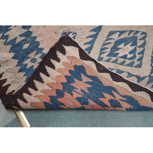 88 - A beige ground Persian tribal runner blue geometric patterned ground and borders, 282cm long x 140cm... 