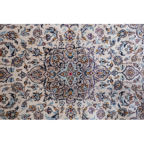 86 - A cream ground Meshed rug with multicolour flower head central medallion, matching spandrels and flo... 