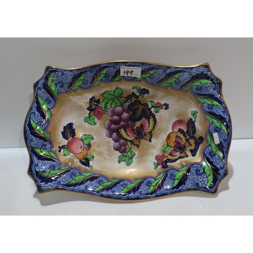 199 - A pair of pottery toby jus, together with a Losol Ware dish decorated with fruit and butterflies