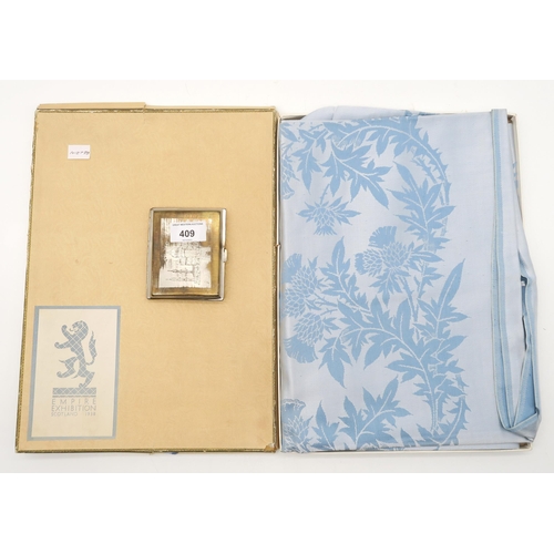 409 - A boxed blue damask table cover from the Empire Exhibition Scotland, 1938, together with an Indian s... 