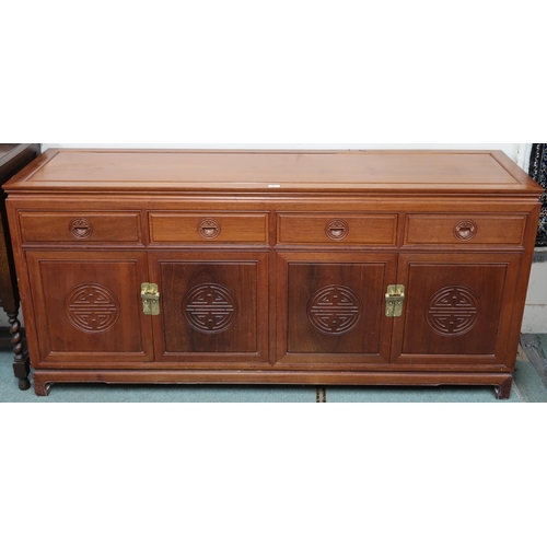 27 - A 20th century Chinese hardwood sideboard with shaped rectangular top over four short drawers over t... 