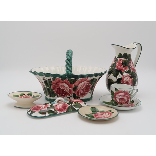 2169 - A COLLECTION OF WEMYSS CABBAGE ROSE PAINTED  POTTERYincluding a basket with twisted handle, 29cm lon... 