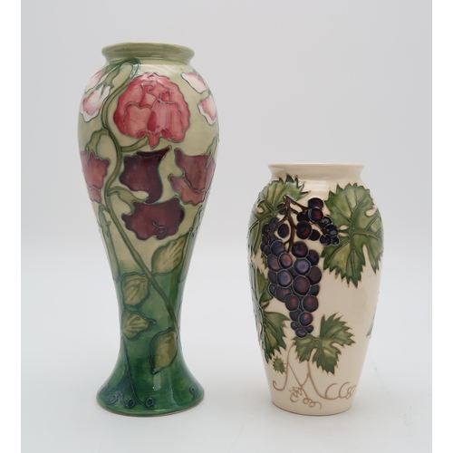 2180 - TWO MOORCROFT COLLECTORS CLUB PIECESincluding a Sweet Pea vase, 27.5cm high together with a Grapevin... 