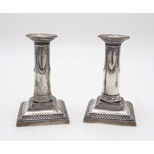 2423 - A PAIR OF LATE VICTORIAN SILVER CANDLESTICKSby Thomas Bradbury, London 1899, of column form, with sw... 