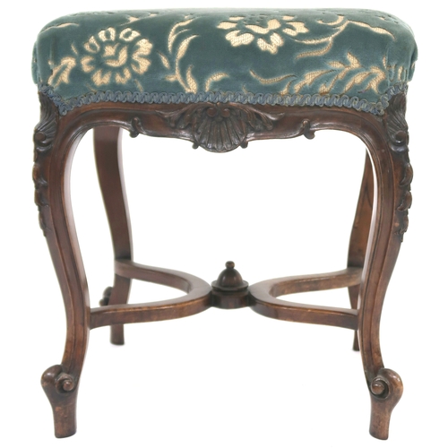 2025 - A VICTORIAN WALNUT FRAMED STOOL with floral upholstered seat on carved cabriole supports joined by c... 
