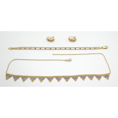 2709 - BI COLOUR GOLD JEWELSan 18ct yellow and white gold triangular fringe necklace with a small bead desi... 