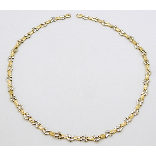 2712 - AN ITALIAN MADE CHAINwith 18ct gold Italian hallmarks, the abstract links are in yellow and white go... 