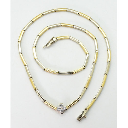 2714 - A DIAMOND FLOWER NECKLACEthe baton links of yellow and white metal have a four petaled flower in the... 