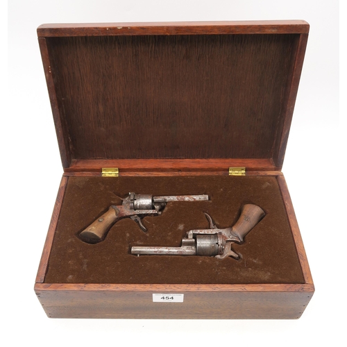 454 - A pair of 19th century Belgian pinfire pistols, housed in a later fitted case