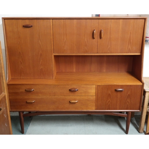 104 - A mid 20th century teak G Plan Fresco sideboard/drinks cabinet with pair of doors alongside fall fro... 