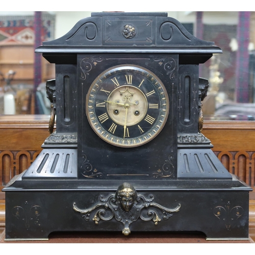 21 - A lot comprising an early 20th century black slate mantel clock with skeletonised dial bearing gilt ... 