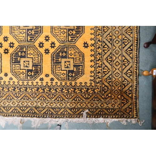 23 - A yellow ground Bokhara rug with lozenge pattern ground and geometric border, 314cm long x 216cm wid... 