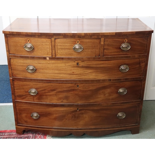 25 - A Victorian mahogany and satinwood inlaid bow front chest of drawers with three short over three lon... 