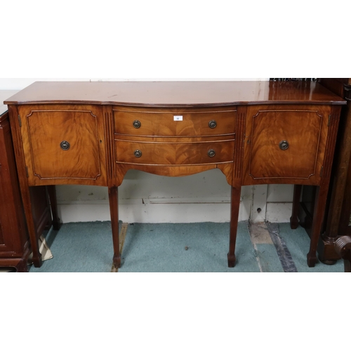 32 - A 20th century mahogany serpentine front sideboard with two central drawers flanked by cabinet doors... 
