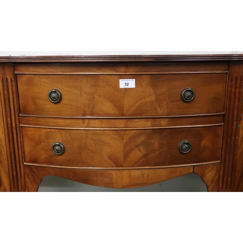 32 - A 20th century mahogany serpentine front sideboard with two central drawers flanked by cabinet doors... 