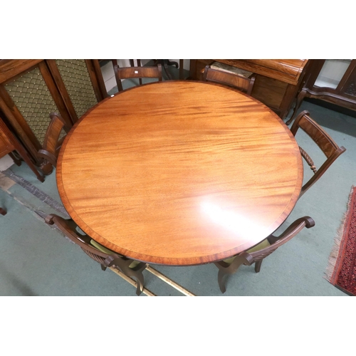 33 - A 20th century mahogany extending dining table and eight chairs, dining table with circular top with... 