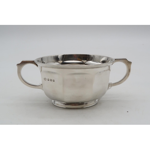 355 - A George V silver twin-handled Christening cup, by Adie Brothers ltd, of faceted form, engraved to t... 